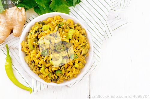 Image of Kitchari with celery in bowl on light board top