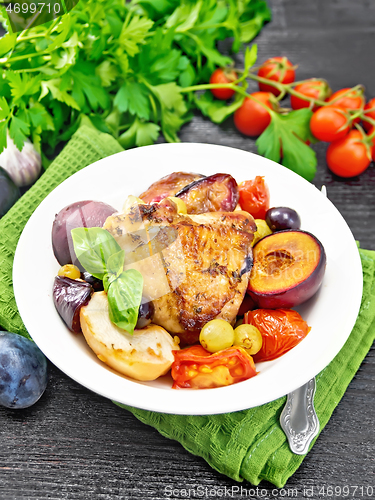 Image of Chicken with fruits and tomatoes in plate on towel