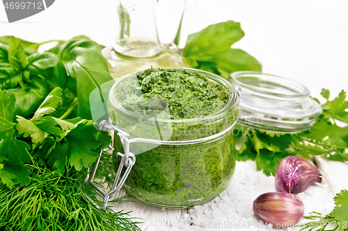 Image of Sauce of spicy greens in jar on white wooden board