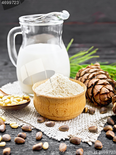 Image of Flour cedar in bowl with nuts on wooden board