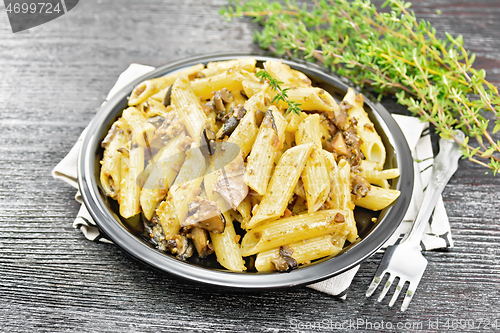 Image of Pasta with mushrooms in plate on board