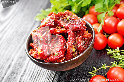 Image of Tomatoes sun-dried in bowl on board