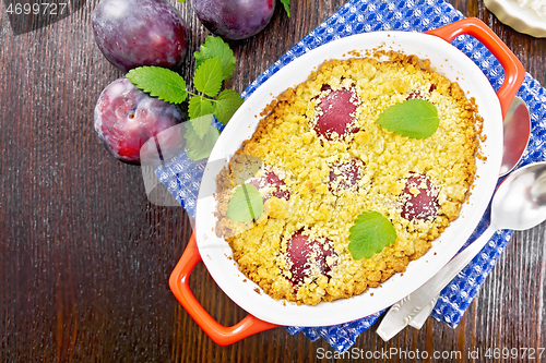 Image of Crumble with plum in brazier on board top