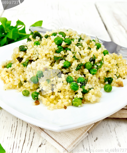 Image of Couscous with spinach in plate on towel