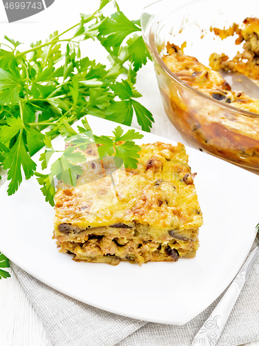 Image of Casserole of meat and eggplant in plate on napkin