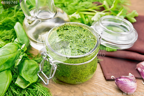 Image of Sauce of spicy greens in jar on wooden board