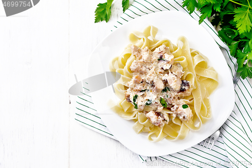 Image of Pasta with salmon in cream on board top