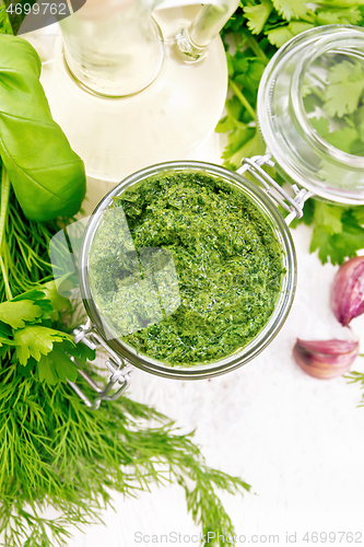 Image of Sauce of spicy greens in jar on white board top