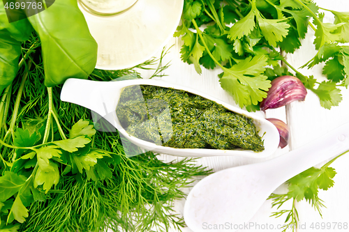 Image of Sauce of spicy greens in gravy boat on board top