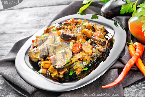 Image of Ragout with eggplant and pepper on black wooden board