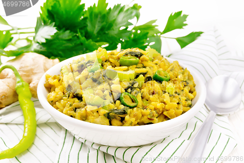 Image of Kitchari with celery in bowl on light board