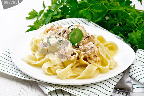 Image of Pasta with salmon in cream on white board