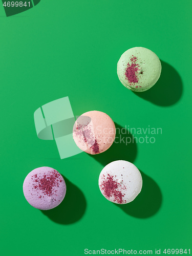 Image of various macaroons on green background