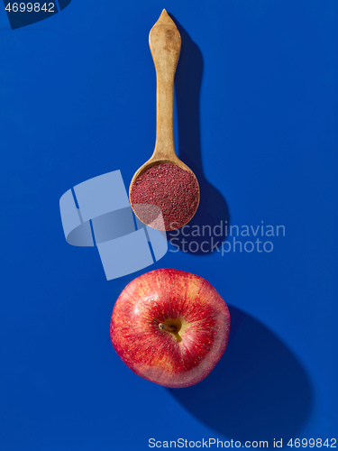 Image of fruit powder in wooden spoon