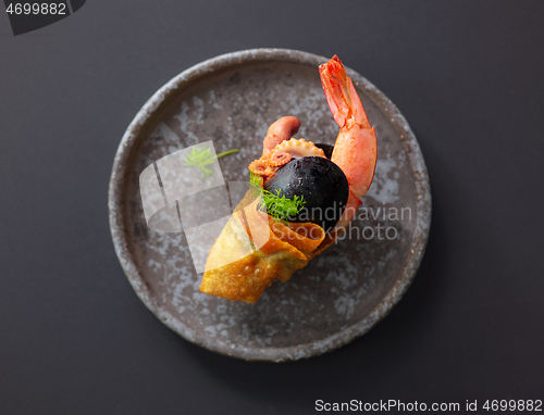 Image of seafood snack on grey plate