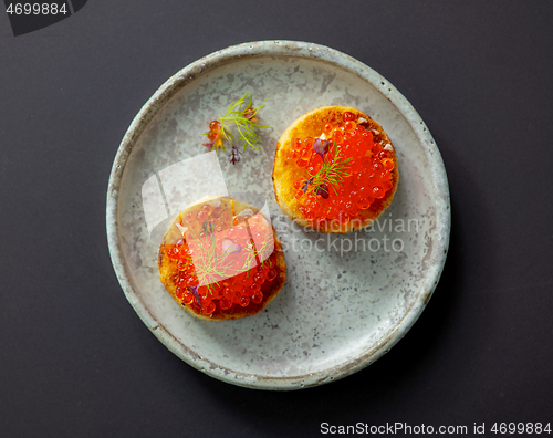 Image of toasted bread with red caviar