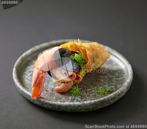 Image of seafood snack on grey plate