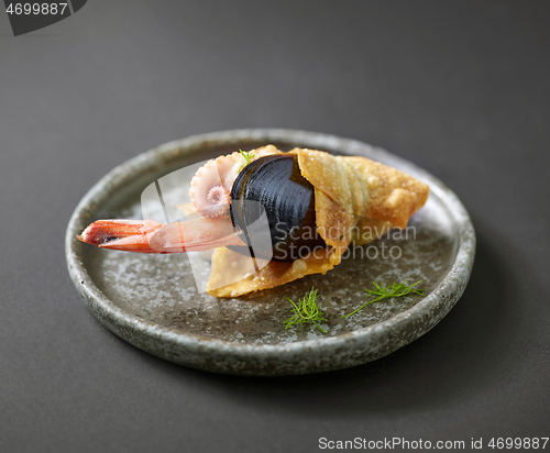 Image of seafood snack on grey plate