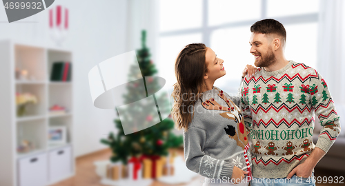 Image of happy couple at christmas ugly sweater party