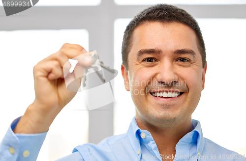 Image of happy smiling man holding keys