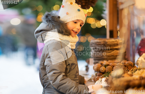 Image of happy little girl at christmas market in winter