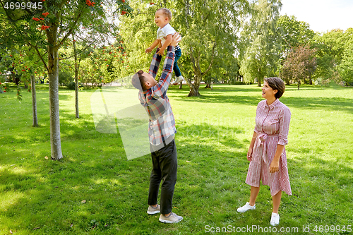 Image of happy family having fun at summer park