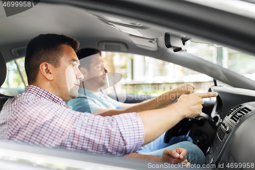 Image of car driving school instructor teaching male driver