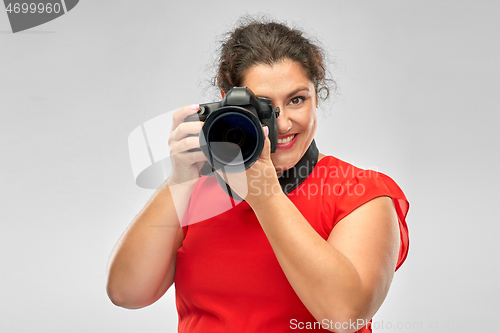 Image of happy woman photographer with digital camera