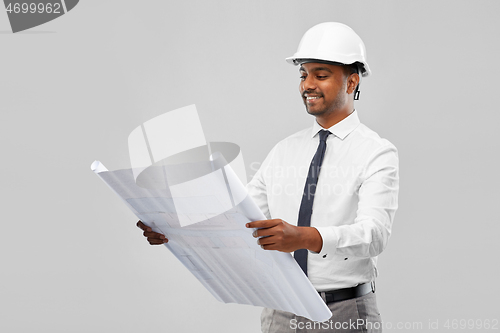 Image of indian male architect in helmet with blueprint