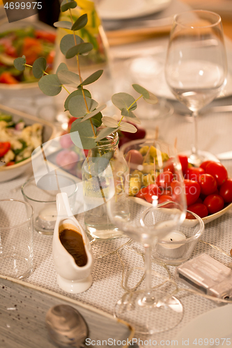 Image of table served with plates, wine glasses and food