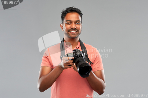 Image of indian man or photographer with digital camera