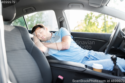 Image of tired man or driver sleeping in car