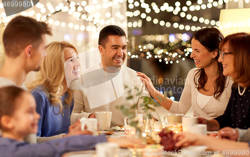 Image of happy family having tea party at home