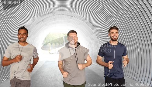 Image of male friends with earphones running outdoors