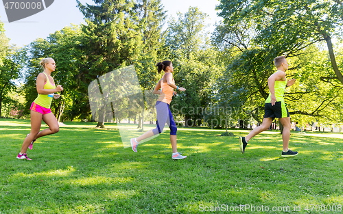 Image of happy young sportsmen racing wit badge numbers