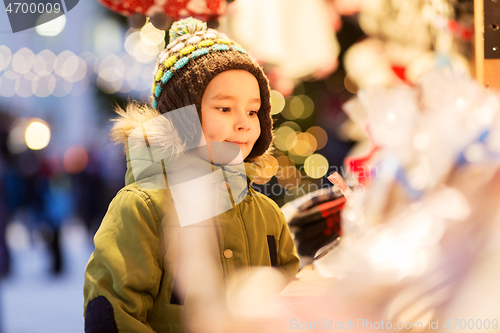 Image of happy little boy at christmas market in winter