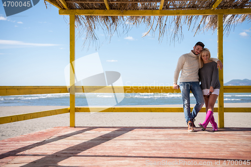 Image of Couple chating and having fun at beach bar