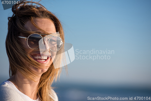 Image of Young woman enjoying the warm autumn day