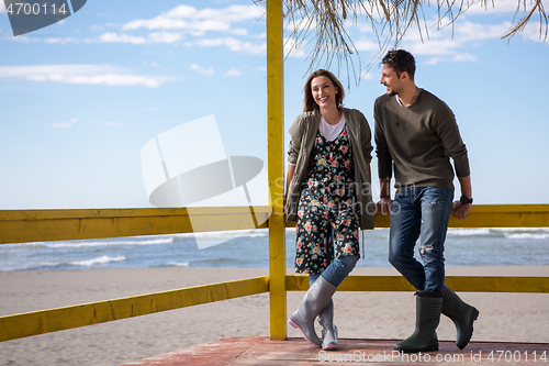 Image of Couple chating and having fun at beach bar