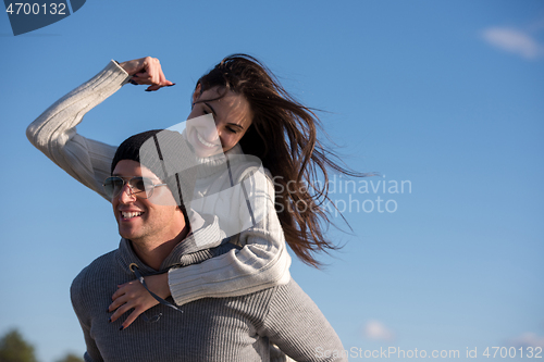 Image of couple having fun at beach during autumn