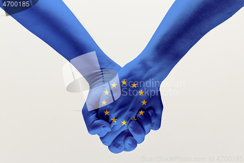 Image of Male hands holding colored in EU flag