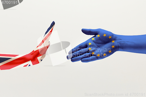 Image of Male hands colored in United Kingdom and European Unity flags