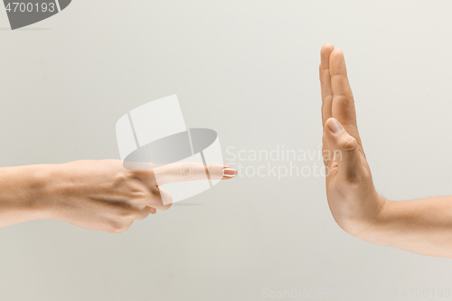 Image of Male and female hands isolated on grey studio background