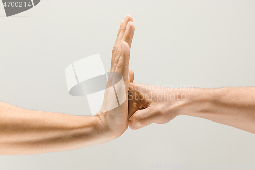 Image of  loseup shot of male hands isolated on grey studio background.
