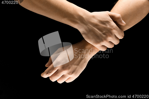 Image of Male hands demonstrating a gesture of getting touch isolated on gray background