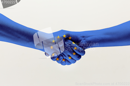 Image of Male hands holding colored in EU flag