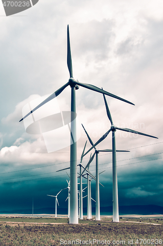 Image of Wind turbines generating electricity in a stormy weather