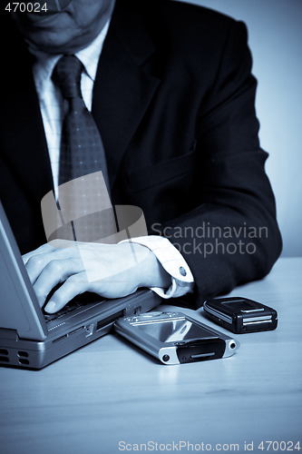 Image of Working senior asian businessman