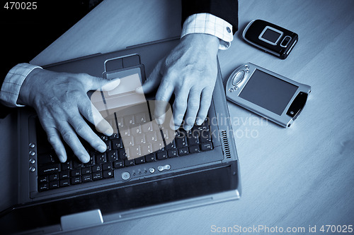 Image of Senior businessman and laptop