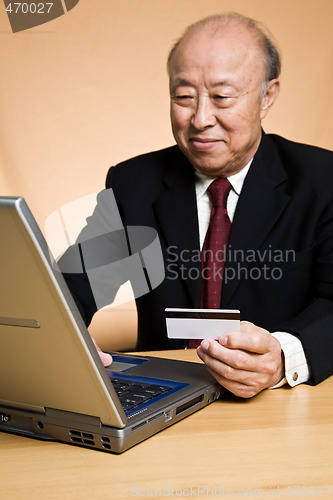 Image of Senior asian businessman shopping online